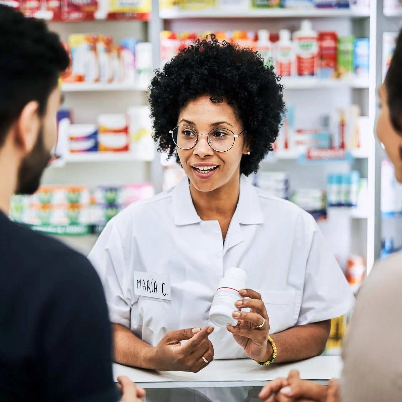 Pharmacy dispenser discussing medication